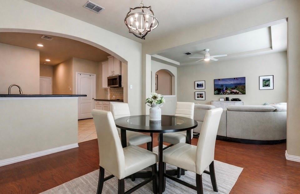 628 Raford Hill Lane Richardson, TX 75081 - Photo 11 of 34 a view of a dining room with furniture and wooden floor