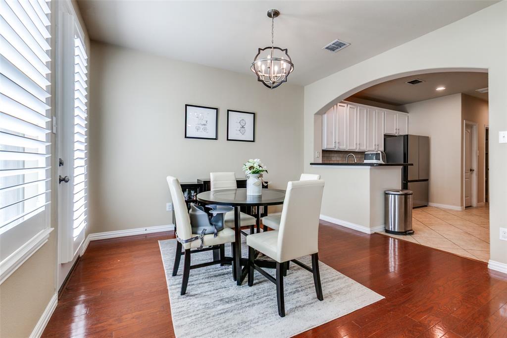 628 Raford Hill Lane Richardson, TX 75081 - Photo 12 of 34 a view of a dining room with furniture and wooden floor
