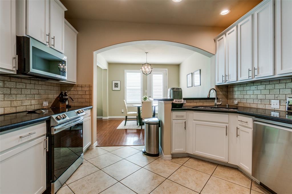 628 Raford Hill Lane Richardson, TX 75081 - Photo 13 of 34 a kitchen with a sink cabinets and stainless steel appliances