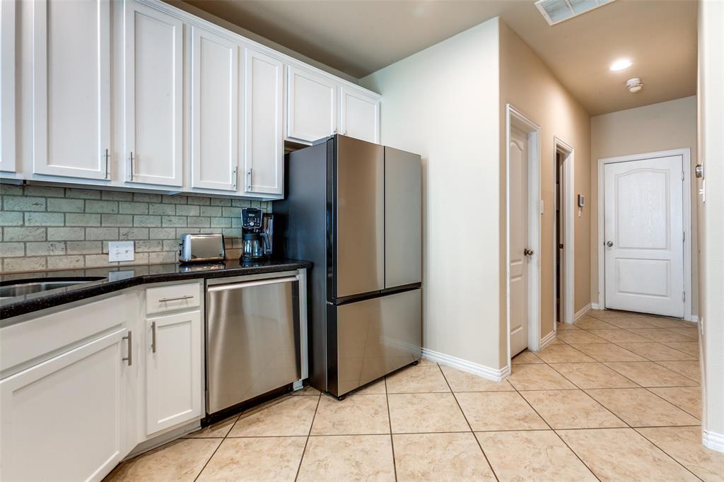 628 Raford Hill Lane Richardson, TX 75081 - Photo 16 of 34 a kitchen with stainless steel appliances granite countertop a refrigerator and a sink