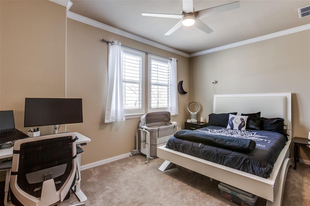 628 Raford Hill Lane Richardson, TX 75081 - Photo 18 of 34 a bedroom with a bed and a flat screen tv