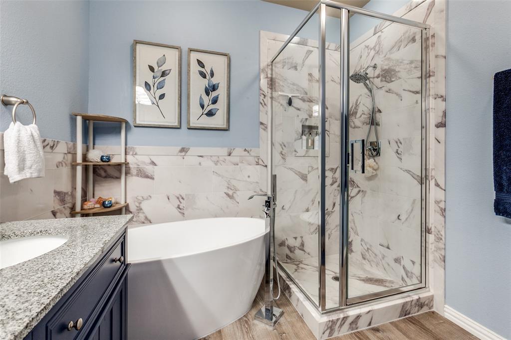 628 Raford Hill Lane Richardson, TX 75081 - Photo 19 of 34 a bathroom with a granite countertop sink a toilet and shower