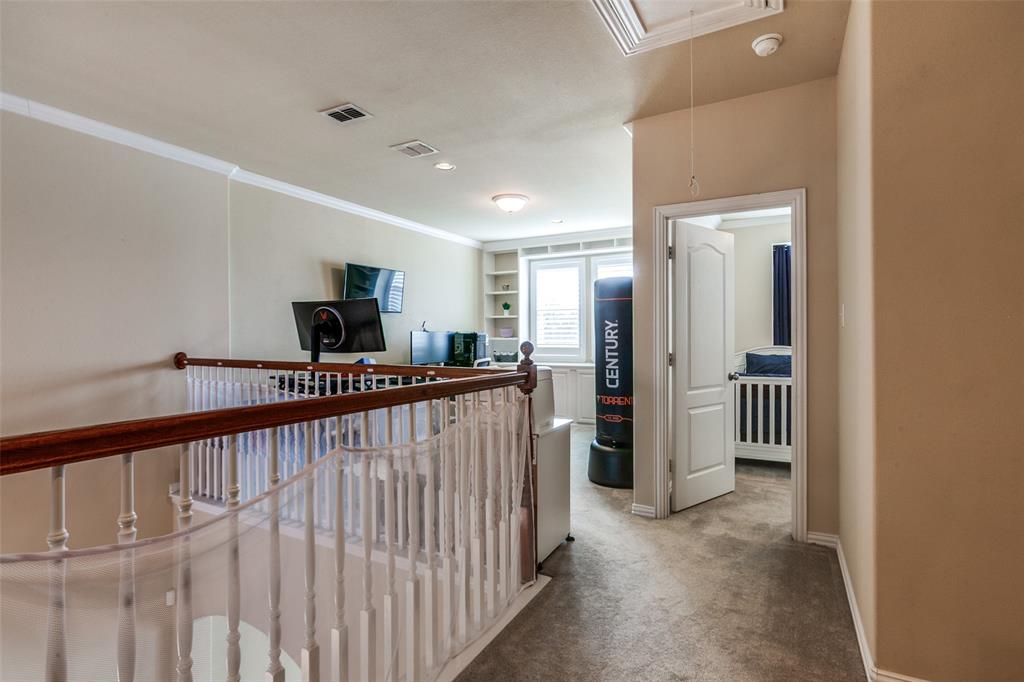 628 Raford Hill Lane Richardson, TX 75081 - Photo 22 of 34 a view of a hallway with a couch and stairs