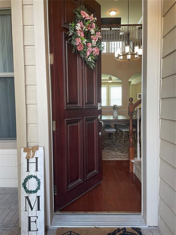 628 Raford Hill Lane Richardson, TX 75081 - Photo 31 of 34 a view of a hallway with dining area wooden floor and a chandelier