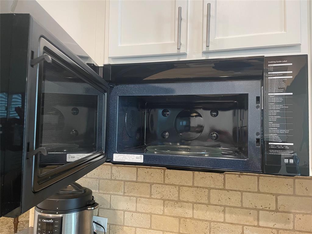 628 Raford Hill Lane Richardson, TX 75081 - Photo 34 of 34 a bathroom with washing machine and mirror