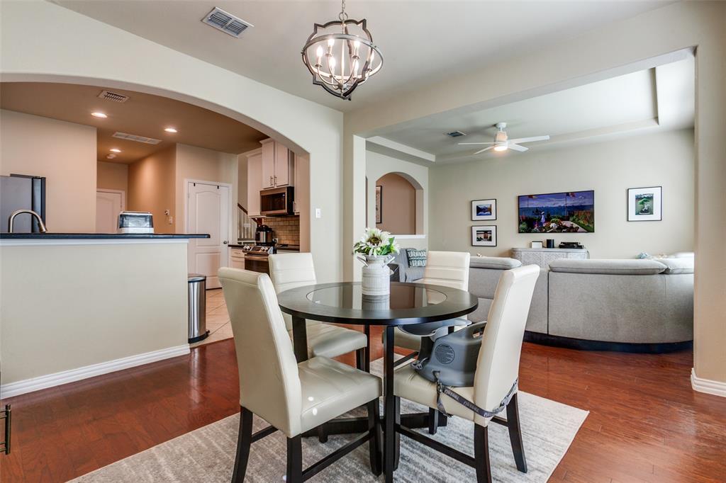 628 Raford Hill Lane Richardson, TX 75081 - Photo 10 of 34 a view of a dining room with furniture and wooden floor
