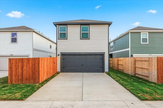 a front view of a house with garage