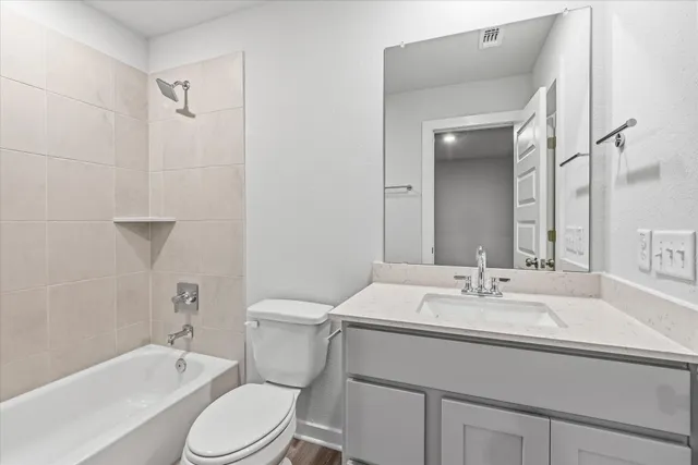 a bathroom with a sink toilet vanity tub and shower