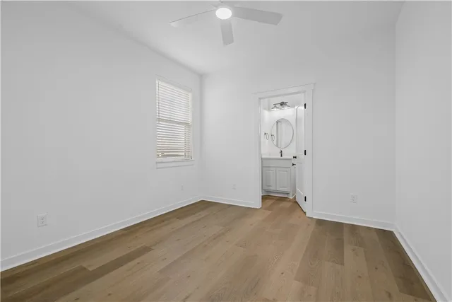a large white kitchen with a stove oven a sink dishwasher and a fireplace with wooden floor