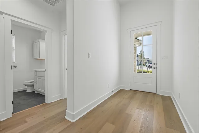 a view of empty room with wooden floor