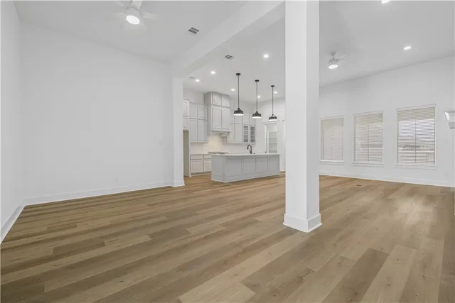 a view of an empty room and wooden floor