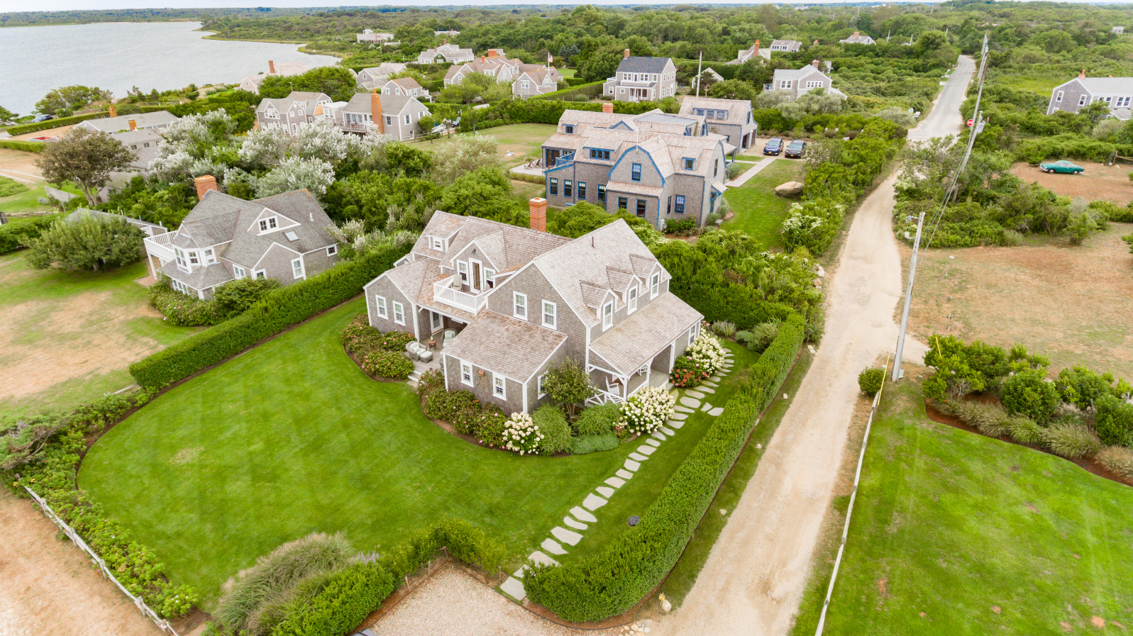 57 Quidnet Road Nantucket, MA 02554 - Photo 4 of 6 an aerial view of a house with a garden and lots of trees