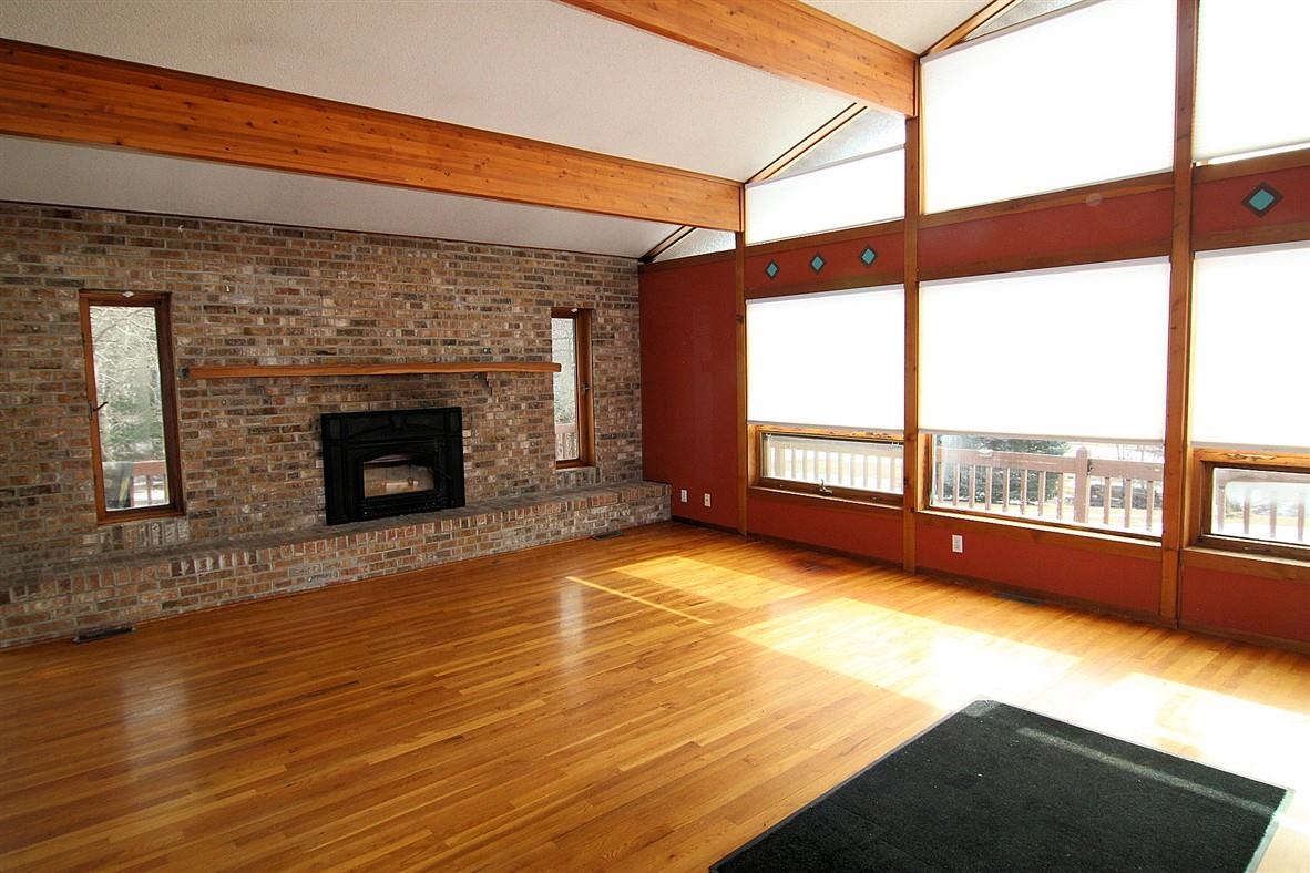 15651 Rock Grove Road Durand, IL 61024 - Photo 20 of 30 a view of an empty room with wooden floor and a fireplace