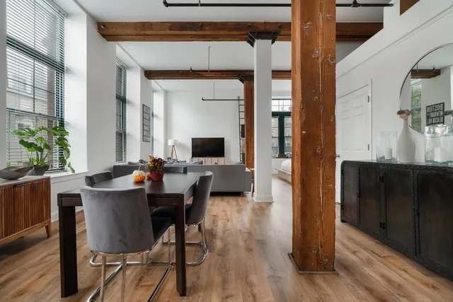 a view of a dining room with furniture window and wooden floor
