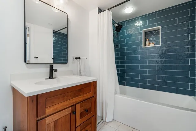 a bathroom with a sink a bathtub and a shower