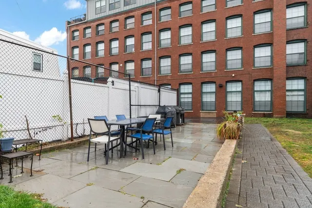 a view of a patio with couches table and chairs with wooden floor