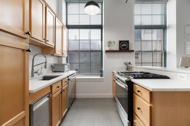 a kitchen with stainless steel appliances granite countertop a stove and a sink