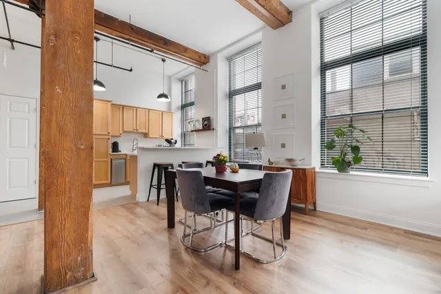 a view of a dining room with furniture and a window