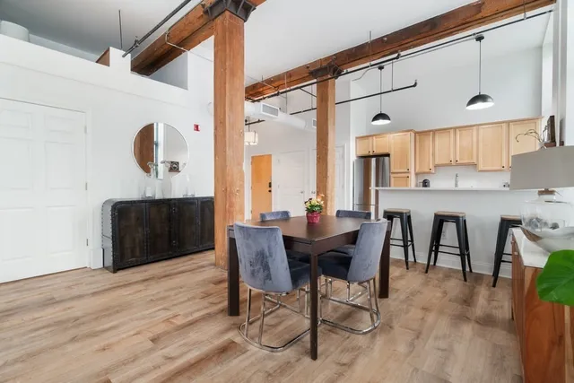 a view of a dining room with furniture and wooden floor