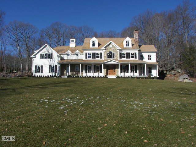 a front view of a building with a garden