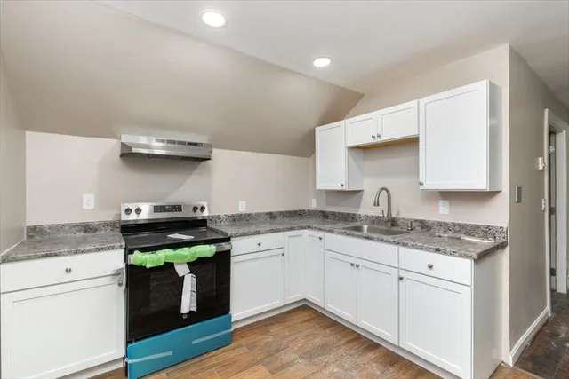 a kitchen with a refrigerator and a sink