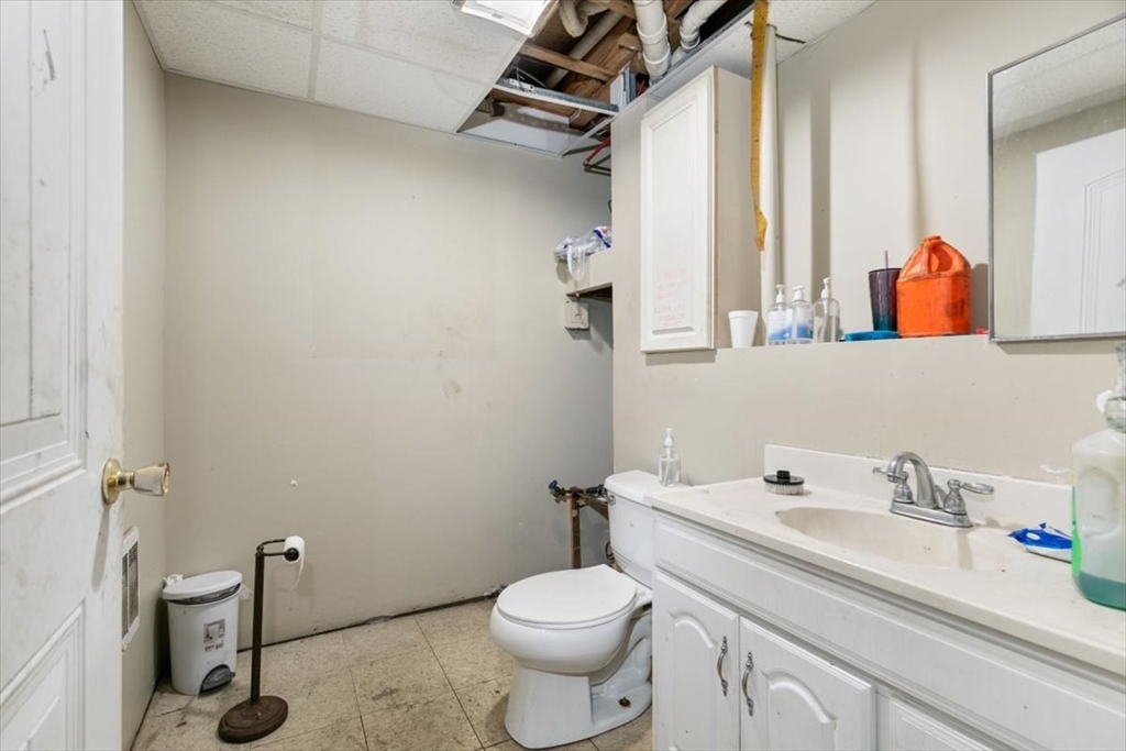 31 Garfield Street Lawrence, MA 01843 - Photo 28 of 31 a bathroom with a sink a toilet and a mirror