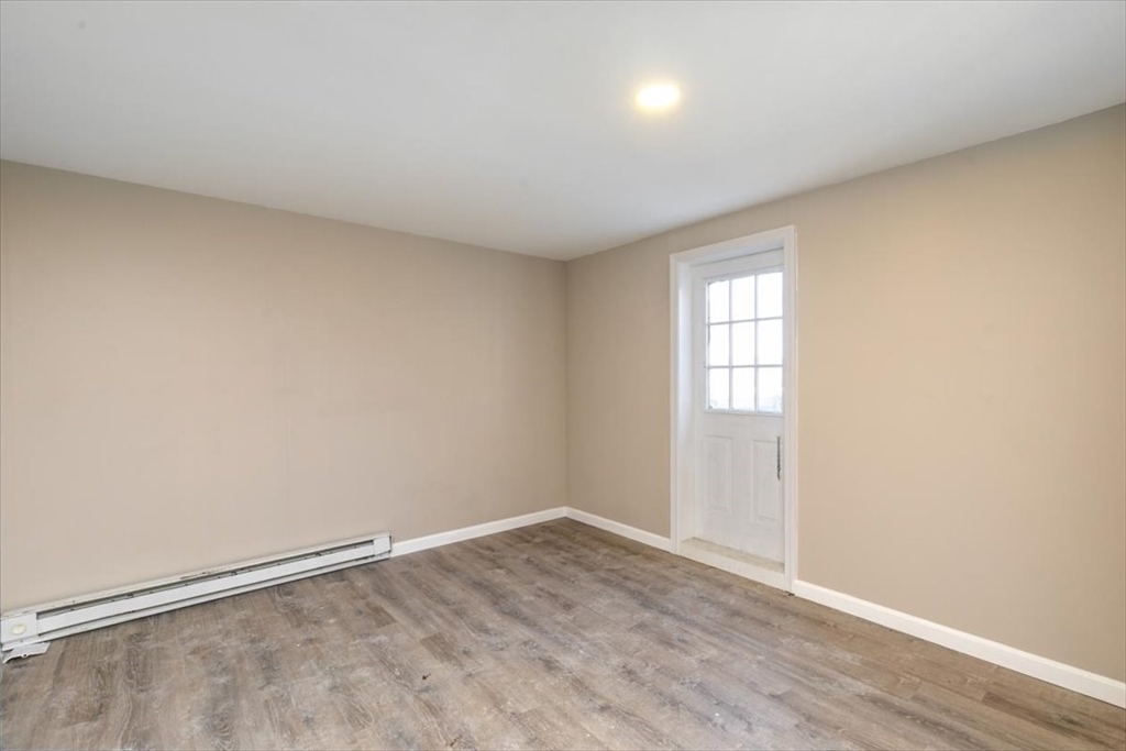 31 Garfield Street Lawrence, MA 01843 - Photo 5 of 31 an empty room with wooden floor and windows