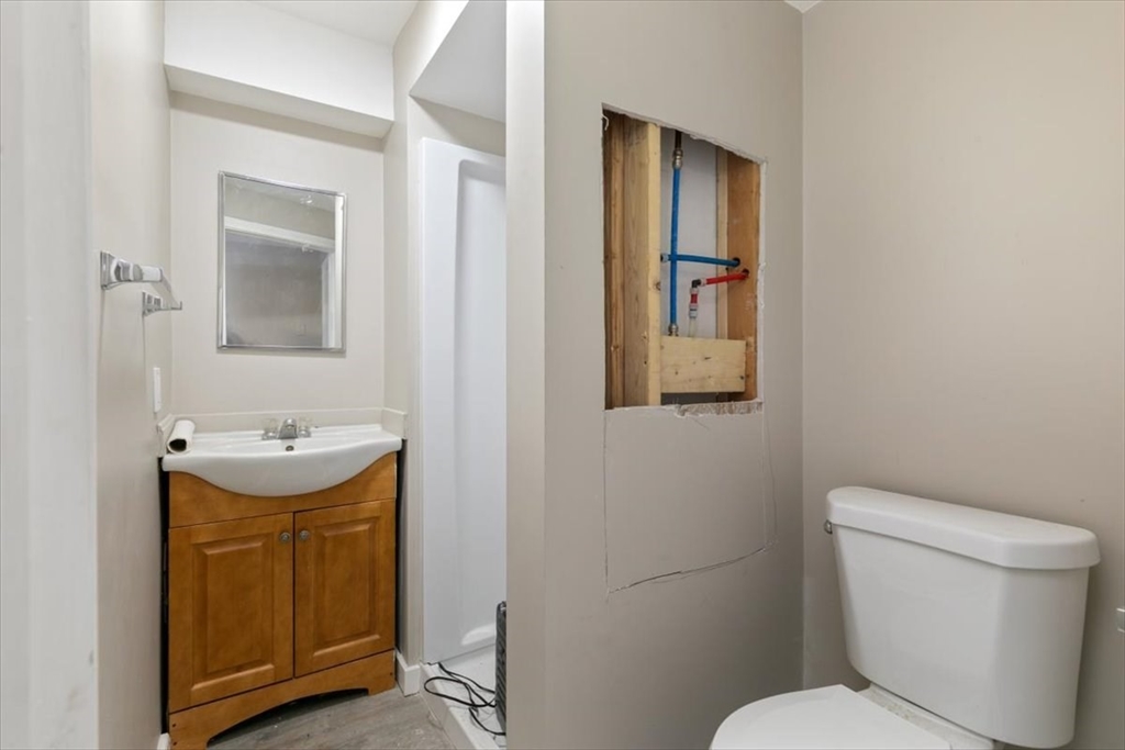 31 Garfield Street Lawrence, MA 01843 - Photo 6 of 31 a bathroom with a toilet sink and mirror