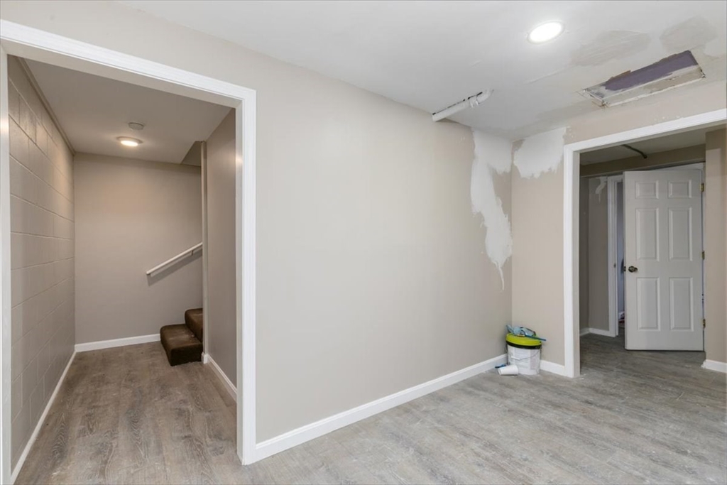 31 Garfield Street Lawrence, MA 01843 - Photo 9 of 31 a view of a hallway with wooden floor and a bathroom