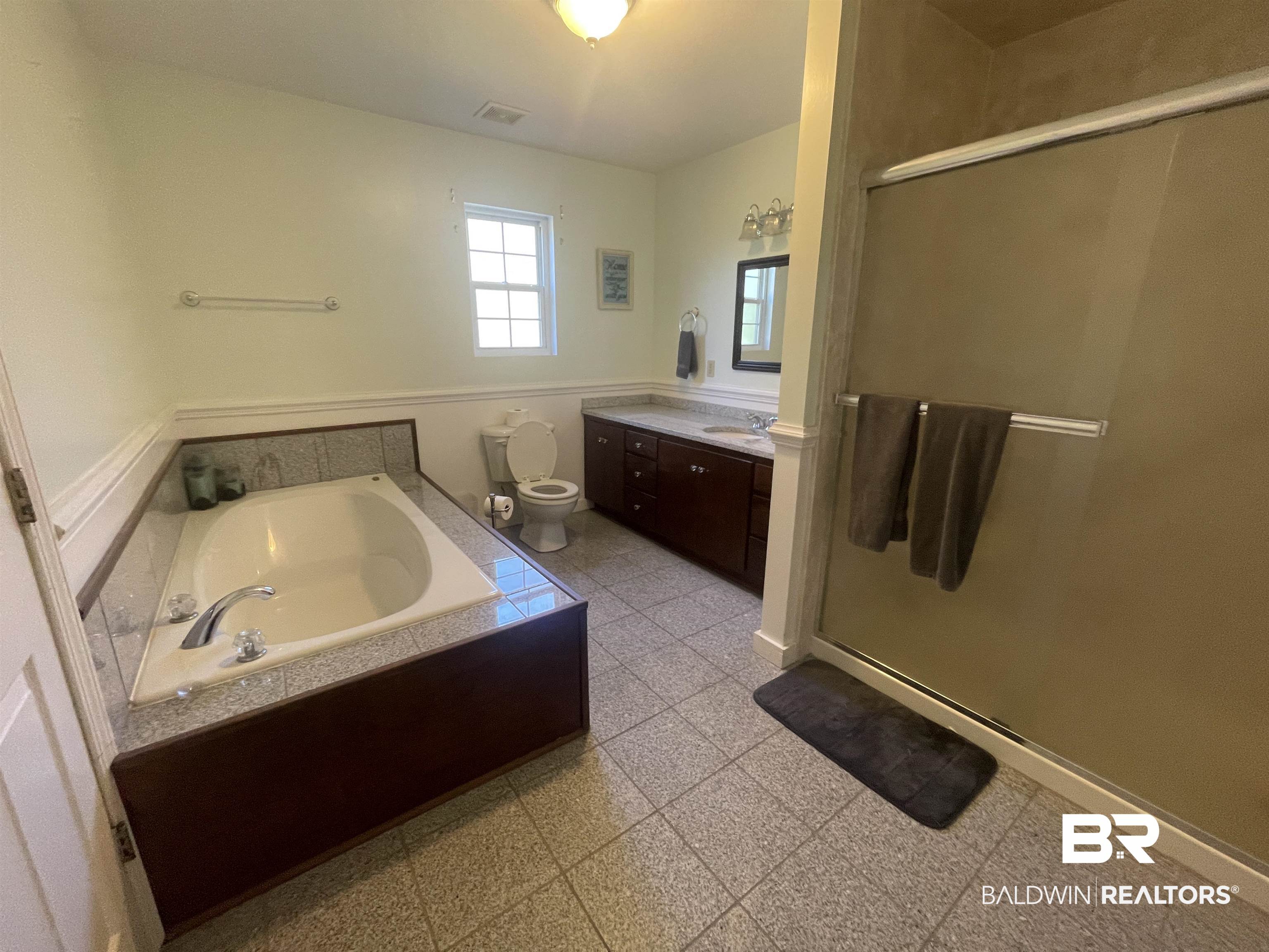 13850 Celeste Road Chunchula, AL 36521 - Photo 14 of 29 Full bath with vanity, a stall shower, and a bath