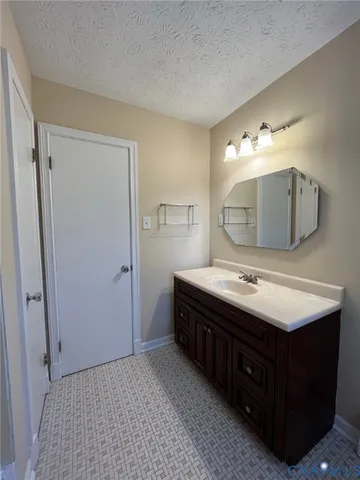 a bathroom with a sink vanity and mirror