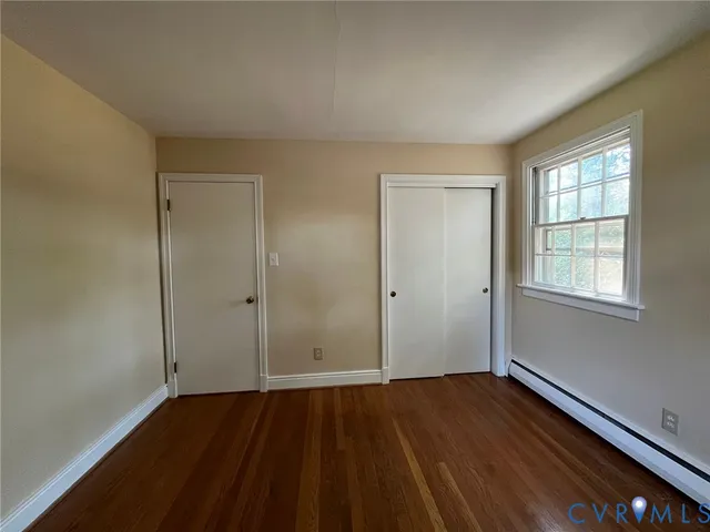 wooden floor in an empty room with a window