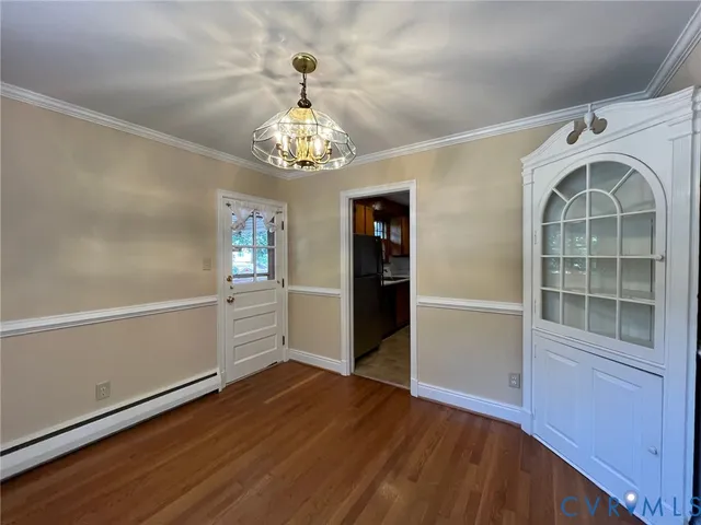 a view of a livingroom with wooden floor and stairs