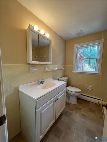 a bathroom with a sink toilet and mirror