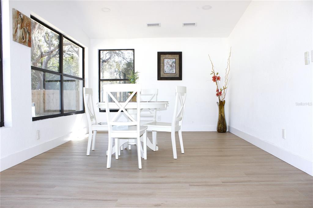 8816 Ashman Road Riverview, FL 33578 - Photo 26 of 52 a dining room with furniture a chandelier and wooden floor