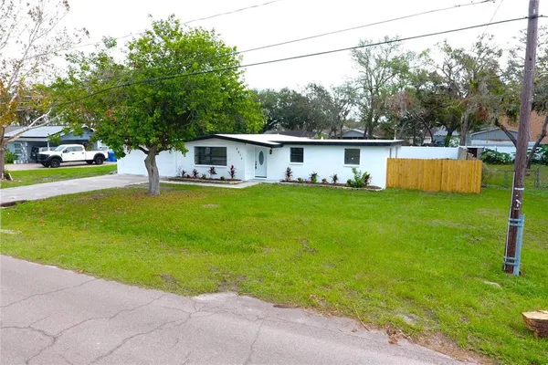 a view of a house with a backyard and a patio