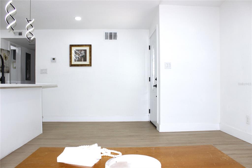 8816 Ashman Road Riverview, FL 33578 - Photo 10 of 52 a view of a bedroom with wooden floor and cabinet