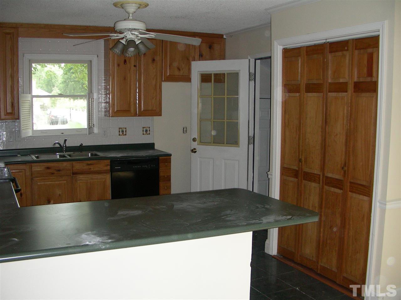 4228 Green Road Raleigh, NC 27604 - Photo 5 of 9 a kitchen with a sink a counter top space and cabinets