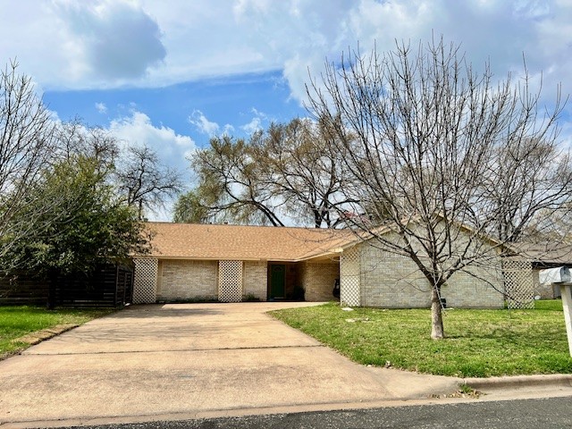 8006 Pinedale Cove Austin, TX 78757 - Photo 1 of 22 a front view of a house with a yard and garage