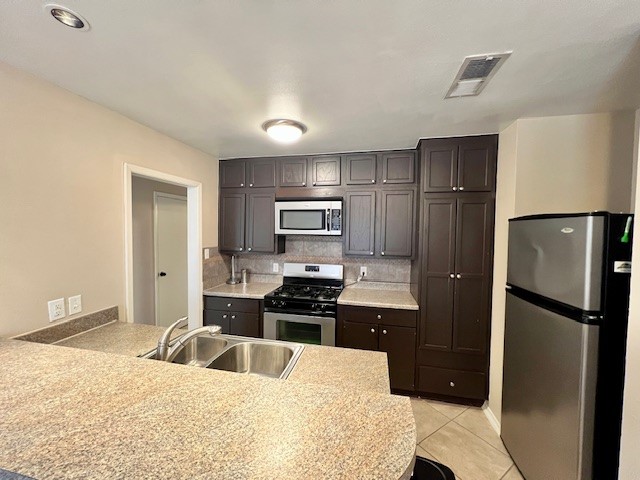 8006 Pinedale Cove Austin, TX 78757 - Photo 6 of 22 a kitchen with granite countertop a refrigerator and a sink