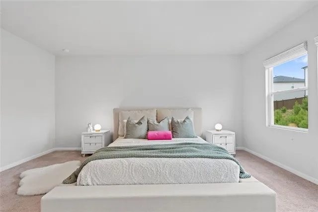 a bedroom with a bed and lamp