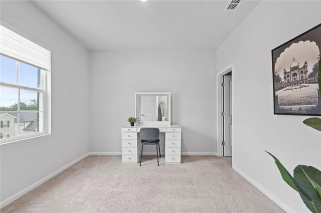 a bedroom with a bed and a lamp