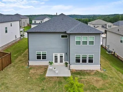 an aerial view of residential houses with outdoor space and parking