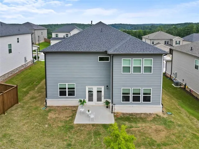 an aerial view of residential houses with outdoor space and parking
