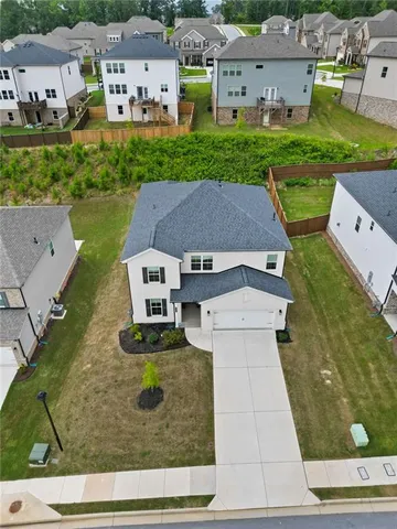 an aerial view of a house with a garden and trees