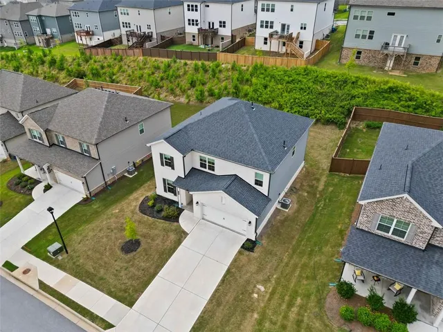 an aerial view of a house with swimming pool