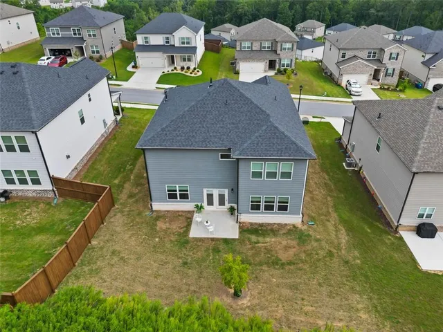 an aerial view of residential houses with yard