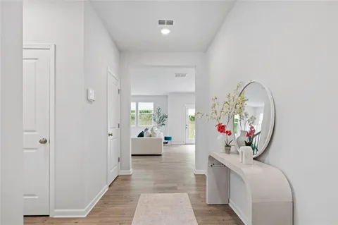 a living room with furniture and a mirror