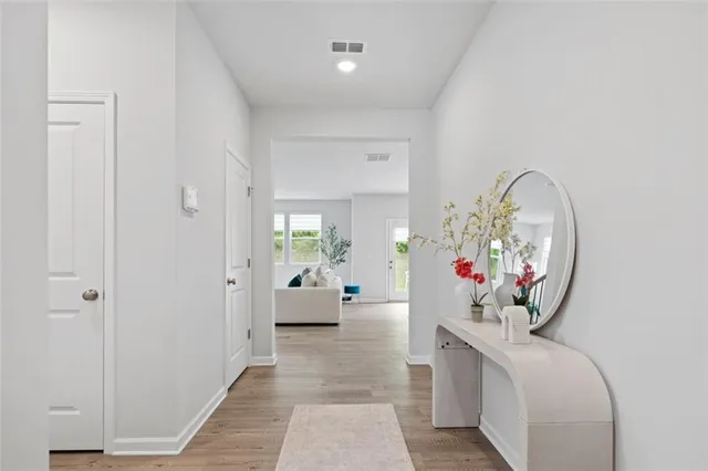 a living room with furniture and a mirror