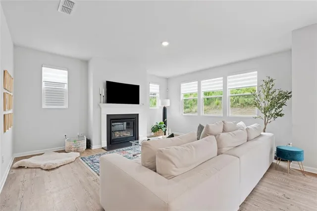 a living room with fireplace furniture and a flat screen tv
